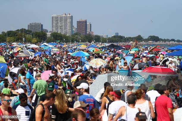 People watch the aircrafts at at North Avenue Beach as aircrafts perform during the 59th Chicago Air and Water Show over Lake Michigan in Chicago,...
