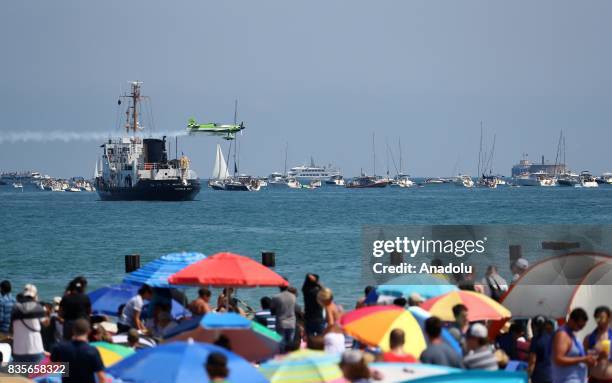 People watch the aircrafts at at North Avenue Beach as aircrafts perform during the 59th Chicago Air and Water Show over Lake Michigan in Chicago,...
