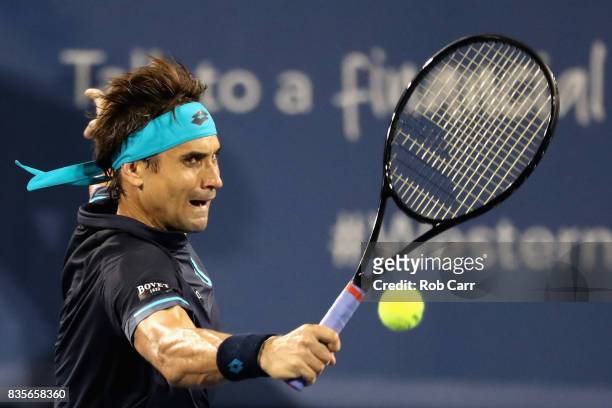 David Ferrer of Spain returns a shot to Nick Kyrgios of Australia during Day 8 of the Western and Southern Open at the Linder Family Tennis Center on...