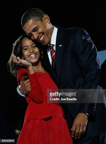 President elect Barack Obama embraces his daughter Malia after Obama gave his victory speech during an election night gathering in Grant Park on...