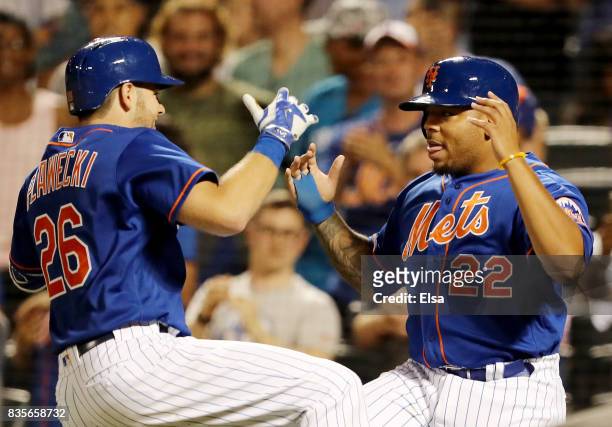 Kevin Plawecki of the New York Mets and Dominic Smith celebrate after Pawlecki drove them both home in the sixth inning against the Miami Marlins on...