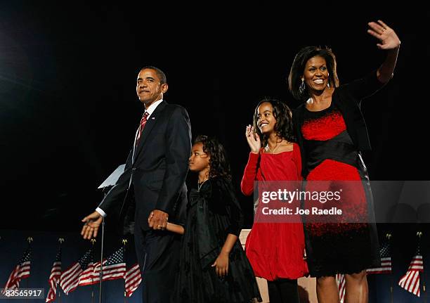 President elect Barack Obama stands on stage along with his wife Michelle and daughters Malia and Sasha during an election night gathering in Grant...