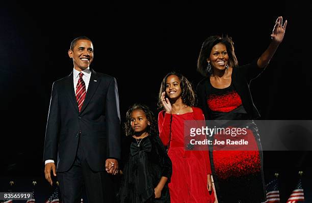 President elect Barack Obama stands on stage along with his wife Michelle and daughters Malia and Sasha during an election night gathering in Grant...