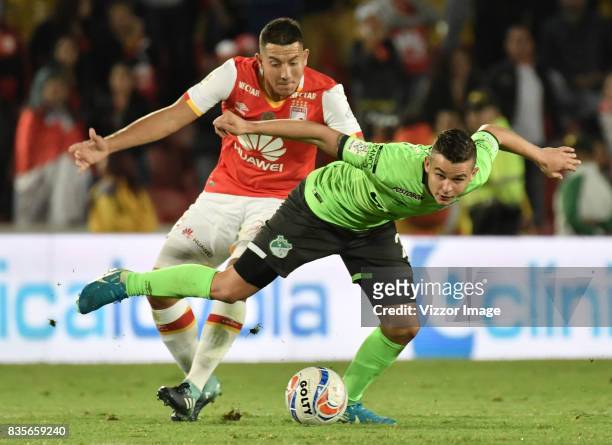 Daniel Buitrago of Independiente Santa Fe struggles for the ball with Nicolas Benedetti of Deportivo Cali during a match between Independiente Santa...