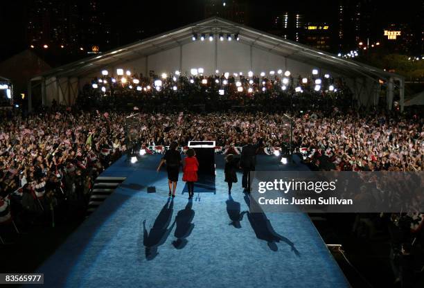 President elect Barack Obama stands on stage along with his wife Michelle and daughters Malia and Sasha during an election night gathering in Grant...