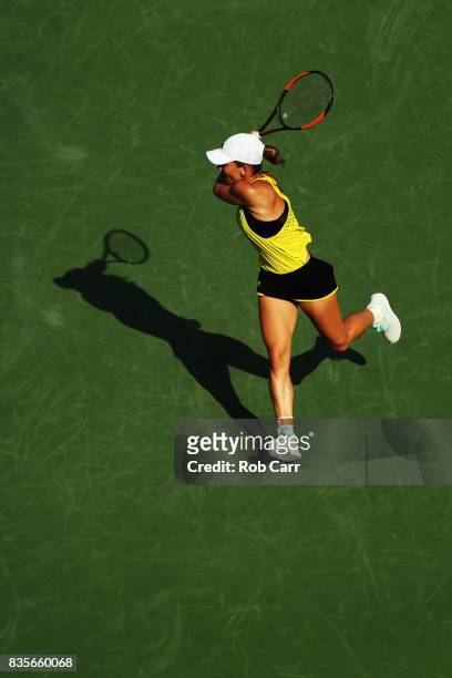 Simona Halep of Romania returns a shot to Sloane Stephens during Day 8 of the Western and Southern Open at the Linder Family Tennis Center on August...