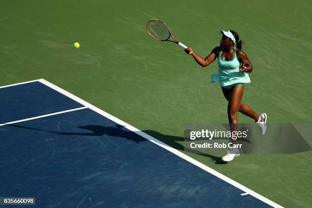 Sloane Stephens returns a shot to Simona Halep of Romania during Day 8 of the Western and Southern Open at the Linder Family Tennis Center on August...