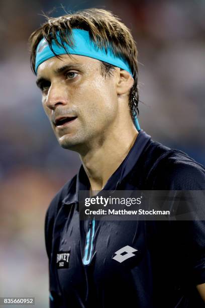 David Ferrer of Spain walks back to the baseline between points while playing Nick Kyrgiuos of Australia during day 8 of the Western & Southern Open...