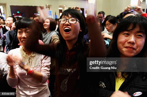 Chinese women react after the announcement that Barack Obama had defeated John McCain to win the US presidential race at an US Election Watch Party...