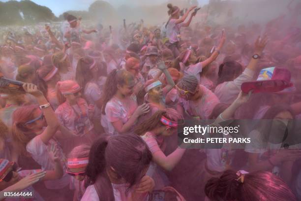 Runners participate in the annual Color Run in Centennial Park in Sydney on August 20, 2017. - The Color Run is a 5km fun run started in the US in...