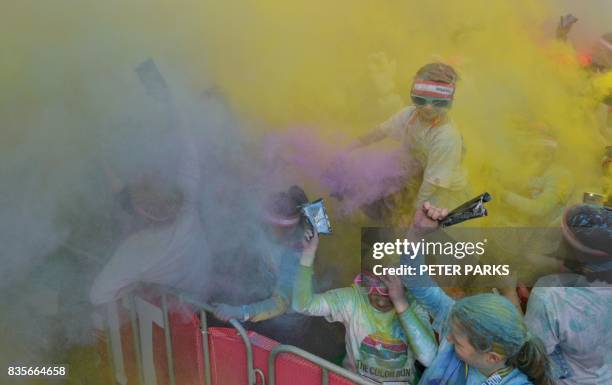 Runners participate in the annual Color Run in Centennial Park in Sydney on August 20, 2017. - The Color Run is a 5km fun run started in the US in...