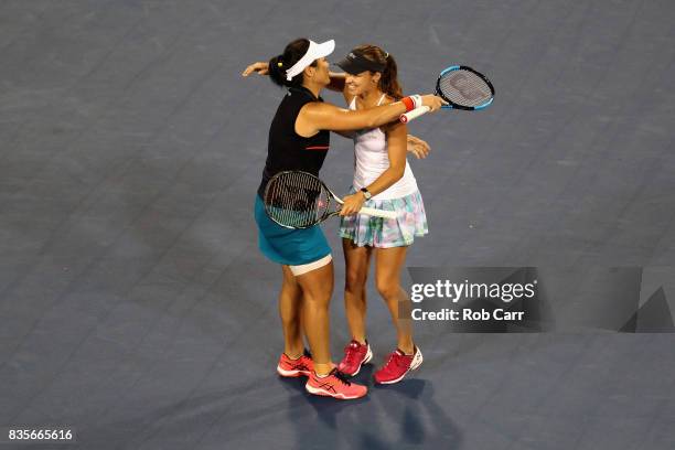 Martina Hingis of Switzerland hugs doubles partner Yung-Jan Chan of Chinese Taipei after defeating Monica Niculescu of Romania and Su-Wei Hsieh of...