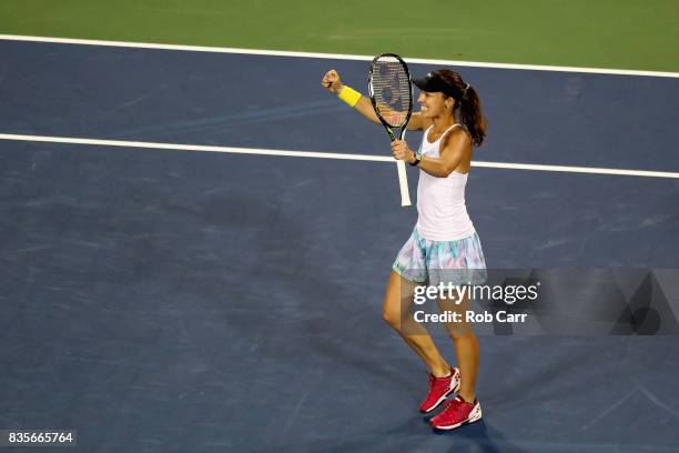 Martina Hingis of Switzerland celebrates match point while looking towards doubles partner Yung-Jan Chan of Chinese Taipei while playing against...