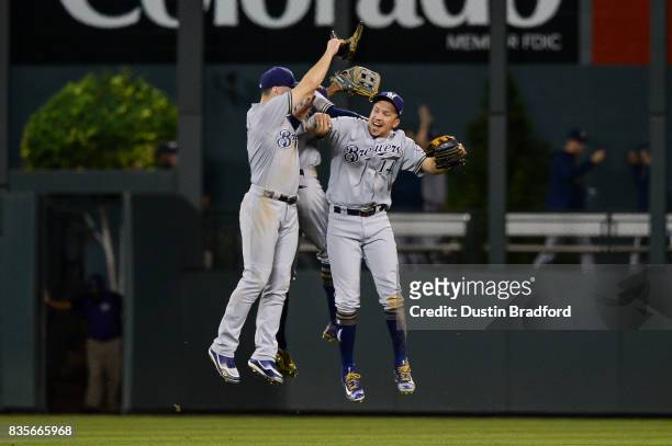 Ryan Braun, Keon Broxton, and Hernan Perez of the Milwaukee Brewers celebrate a 6-3 win over the Colorado Rockies at Coors Field on August 19, 2017...