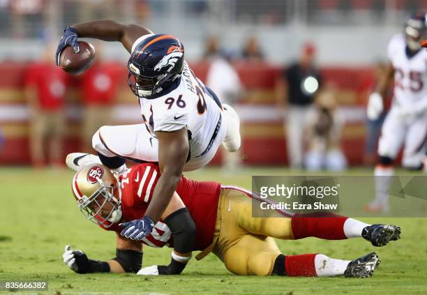 Shelby Harris of the Denver Broncos is tacked by Joe Staley of the San Francisco 49ers after Harris recovered a fumble and was running back with the...