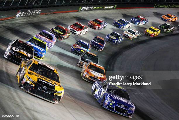 Matt Kenseth, driver of the DEWALT/Flexvolt Toyota, and Jimmie Johnson, driver of the Lowe's Chevrolet, lead a pack of cars during the Monster Energy...