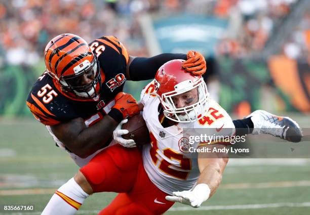 Vontaze Burfict of the Cincinnati Bengals tackles Anthony Sherman of the Kansas City Chiefs during the preseason game at Paul Brown Stadium on August...