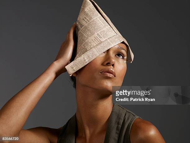 woman with newspaper hat - newcraft stock-fotos und bilder