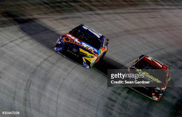 Kyle Busch, driver of the M&M's Caramel Toyota, and Erik Jones, driver of the 5-hour ENERGY Extra Strength Toyota, race during the Monster Energy...