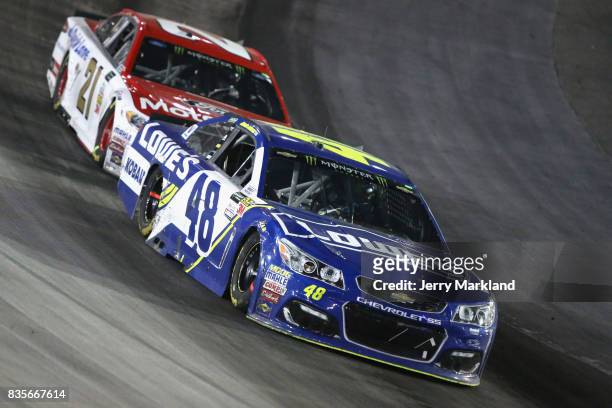 Jimmie Johnson, driver of the Lowe's Chevrolet, leads Ryan Blaney, driver of the Motorcraft/Quick Lane Tire & Auto Center Ford, during the Monster...