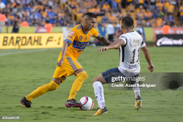 Ismael Sosa of Tigres fights for the ball with Bryan Rabello of Pumas during the 5th round match between Tigres and Pumas as part of the Torneo...