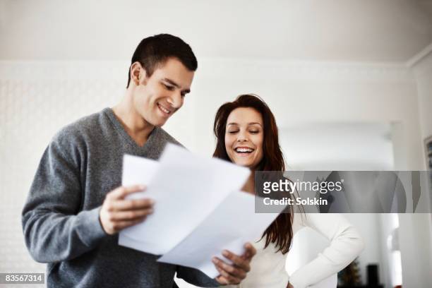young couple looking at documents together - demonstration against the marriage for all bill stock pictures, royalty-free photos & images