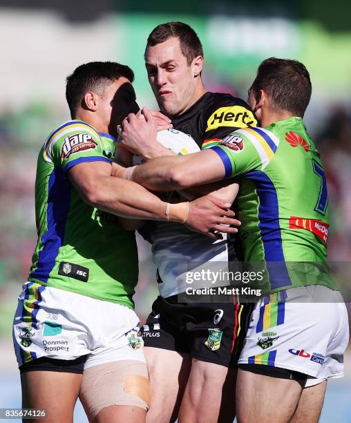 Isaah Yeo of the Panthers is tackled during the round 24 NRL match between the Canberra Raiders and the Penrith Panthers at GIO Stadium on August 20,...