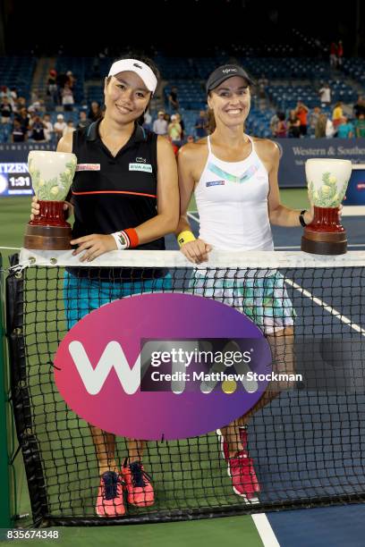 Yung-Jan Chan of Taipei and Martina Hingis of Switzerland pose for photographers with the winner's trophy after defeating Su-Wei Hsieh of Taipei and...