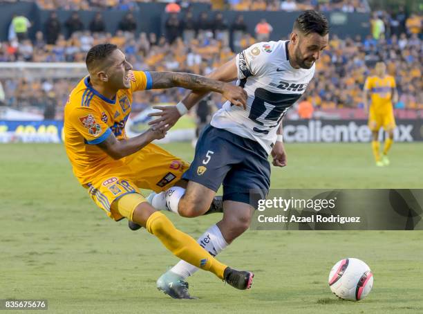 Ismael Sosa of Tigres fights for the ball with Alan Mendoza of Pumas during the 5th round match between Tigres and Pumas as part of the Torneo...