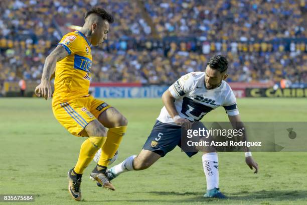 Eduardo Vargas of Tigres fights for the ball with Alan Mendoza of Pumas during the 5th round match between Tigres and Pumas as part of the Torneo...