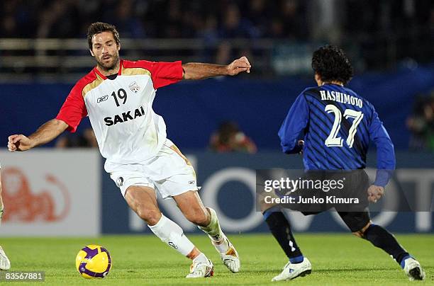 Hideo Hashimoto of Gamba Osaka and Sasa Ognenovski of Adelaide United battle for the ball during the AFC Champions League Final first leg match...