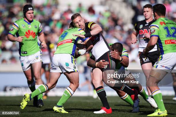 Bryce Cartwright of the Panthers is tackled during the round 24 NRL match between the Canberra Raiders and the Penrith Panthers at GIO Stadium on...