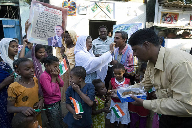 indian-siddi-tribals-hold-posters-of-us-president-elect-barack-obama-and-indian-national-flags.jpg