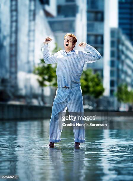 man standing on the water in pyjamas - schlafanzug stock-fotos und bilder