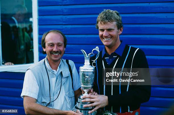 Scottish golfer Sandy Lyle poses with sports photographer Phil Sheldon after winning the British Open at Royal St George's Golf Club, July 1985.