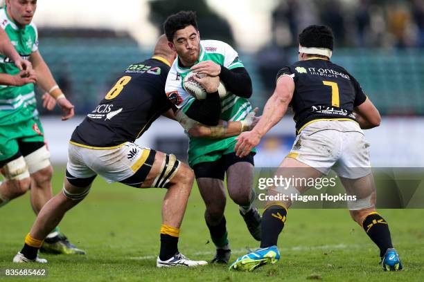 Nehe Milner-Skudder of Manawatu is tackled by Brad Shields and Du'Plessis Kirifi of Wellington during the round one Mitre 10 Cup match between...