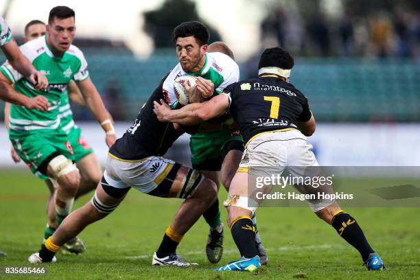 Nehe Milner-Skudder of Manawatu is tackled by Brad Shields and Du'Plessis Kirifi of Wellington during the round one Mitre 10 Cup match between...