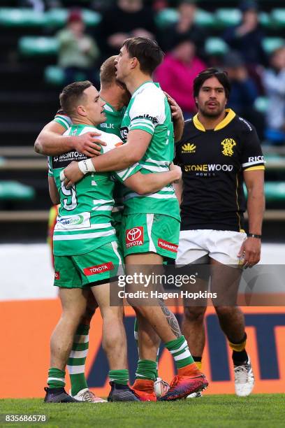 Curtis Reid of Manawatu celebrates his try with Kayne Hammington and Ambrose Curtis during the round one Mitre 10 Cup match between Manawatu and...