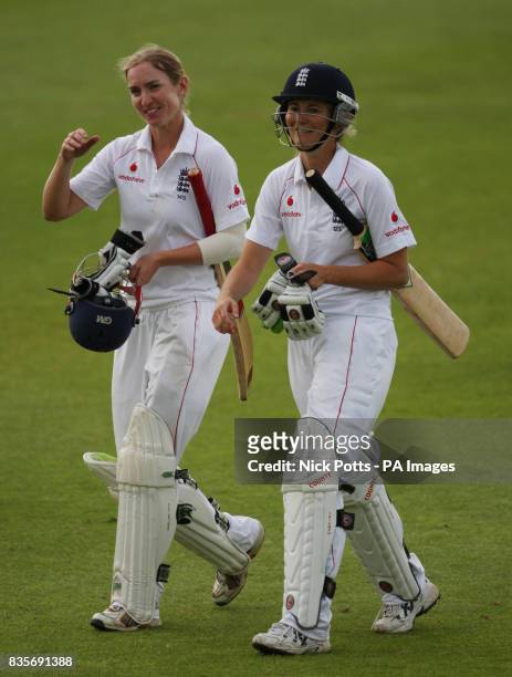England captain Charlotte Edwards and teammate Beth Morgan celebrate retaining the Ashes as they leave the field after batting until the end of play...