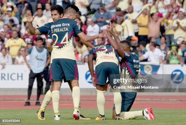 William da Silva of America celebrates with teammates after scoring the first goal of his team during the fifth round match between Lobos BUAP and...