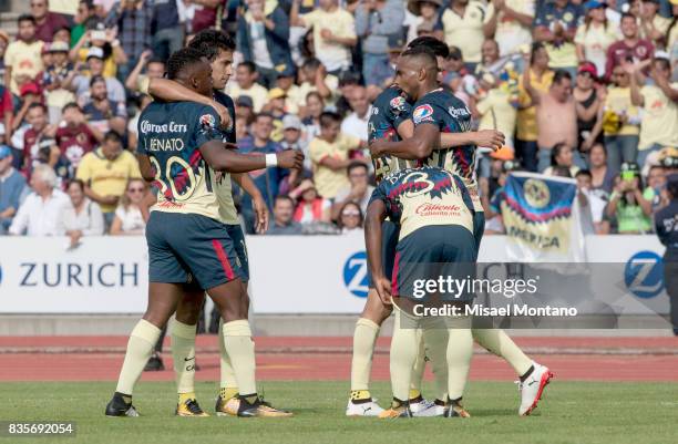 William da Silva of America celebrates with teammates after scoring the first goal of his team during the fifth round match between Lobos BUAP and...