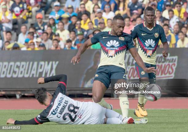 Carlos Morales of Lobos BUAP fights for the ball with William Da Silva of America during the fifth round match between Lobos BUAP and America as part...