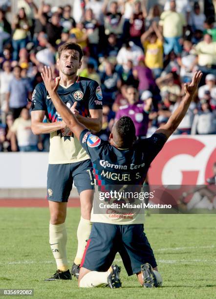 Miguel Angel Samudio of America celebrates the third goal of his team scored by Oribe Peralta during the fifth round match between Lobos BUAP and...