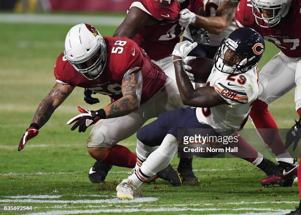 Tarik Cohen of the Chicago Bears lunges forward with the ball after being hit by Scooby Wright III of the Arizona Cardinals during the first half at...