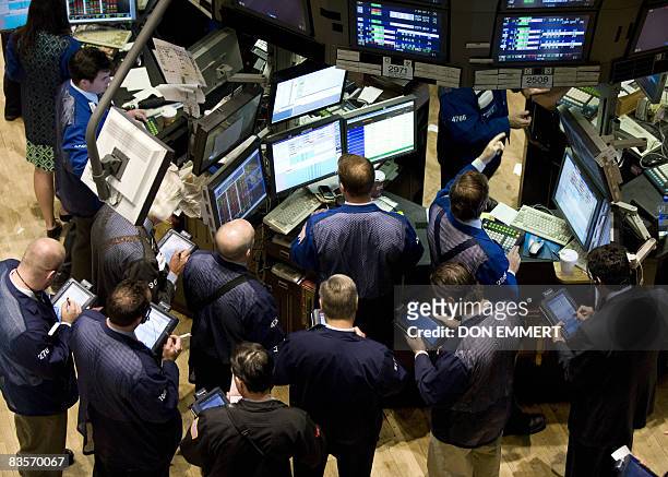 Traders work on the floor of the New York Stock Exchange November 5, 2008 in New York. Wall Street and European stocks fell Wednesday as investors...