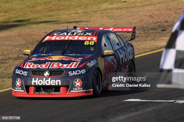 Jamie Whincup drives the Red Bull Holden Racing Team Holden Commodore VF takes the chequred flag to win race 18 for the Sydney SuperSprint, which is...