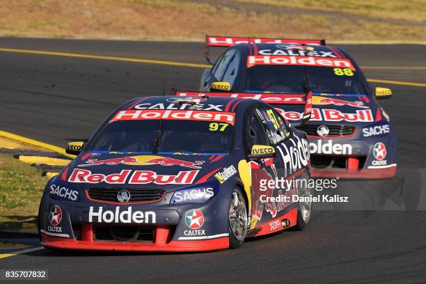 Shane Van Gisbergen drives the Red Bull Holden Racing Team Holden Commodore VF leads Jamie Whincup drives the Red Bull Holden Racing Team Holden...