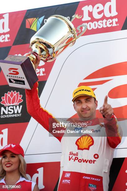 Fabian Coulthard driver of the Shell V-Power Racing Team Ford Falcon FGX celebrates on the podium after race 18 for the Sydney SuperSprint, which is...