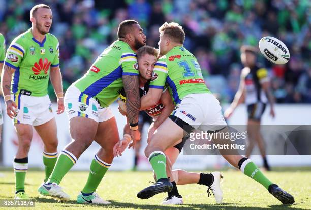 Matt Moylan of the Panthers offloads the ball in a tackle during the round 24 NRL match between the Canberra Raiders and the Penrith Panthers at GIO...