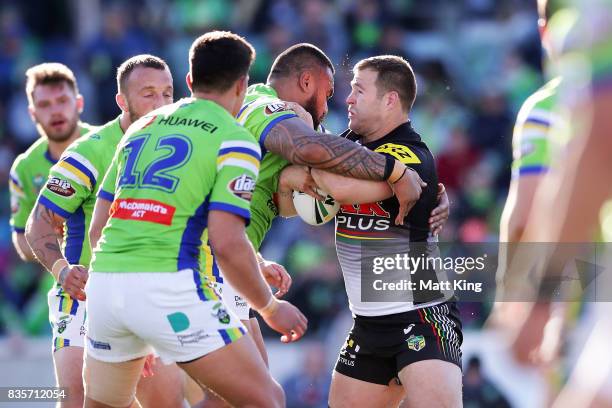 Trent Merrin of the Panthers is tackled during the round 24 NRL match between the Canberra Raiders and the Penrith Panthers at GIO Stadium on August...